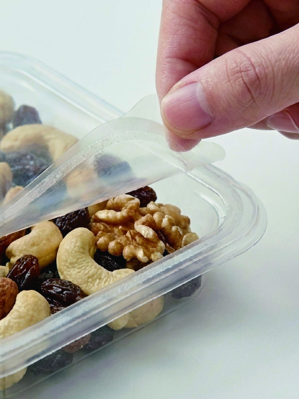 A tray of nuts opened and reclosed by hand